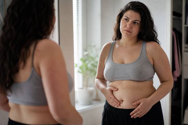 Learn why PCOS belly fat happens, how insulin resistance and hormones affect abdominal weight gain, and what nutrition, exercise, and treatment strategies help most.