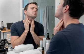Adult acne in men often comes from hormones, shaving irritation, sweat, friction, and clogged pores. Learn how to tell acne from razor bumps, build a simple routine, choose treatments, and know when to see a dermatologist.